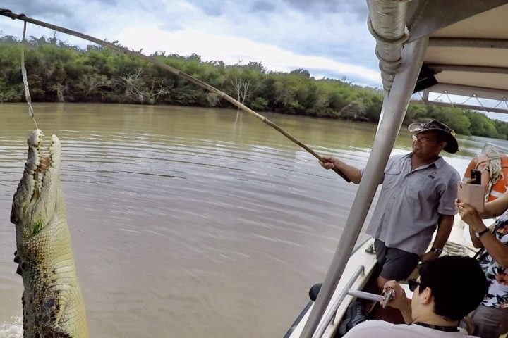 a group of people in a boat on a body of water